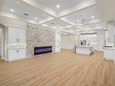 LVP great room coffered ceiling stone fireplace Holiday FL
