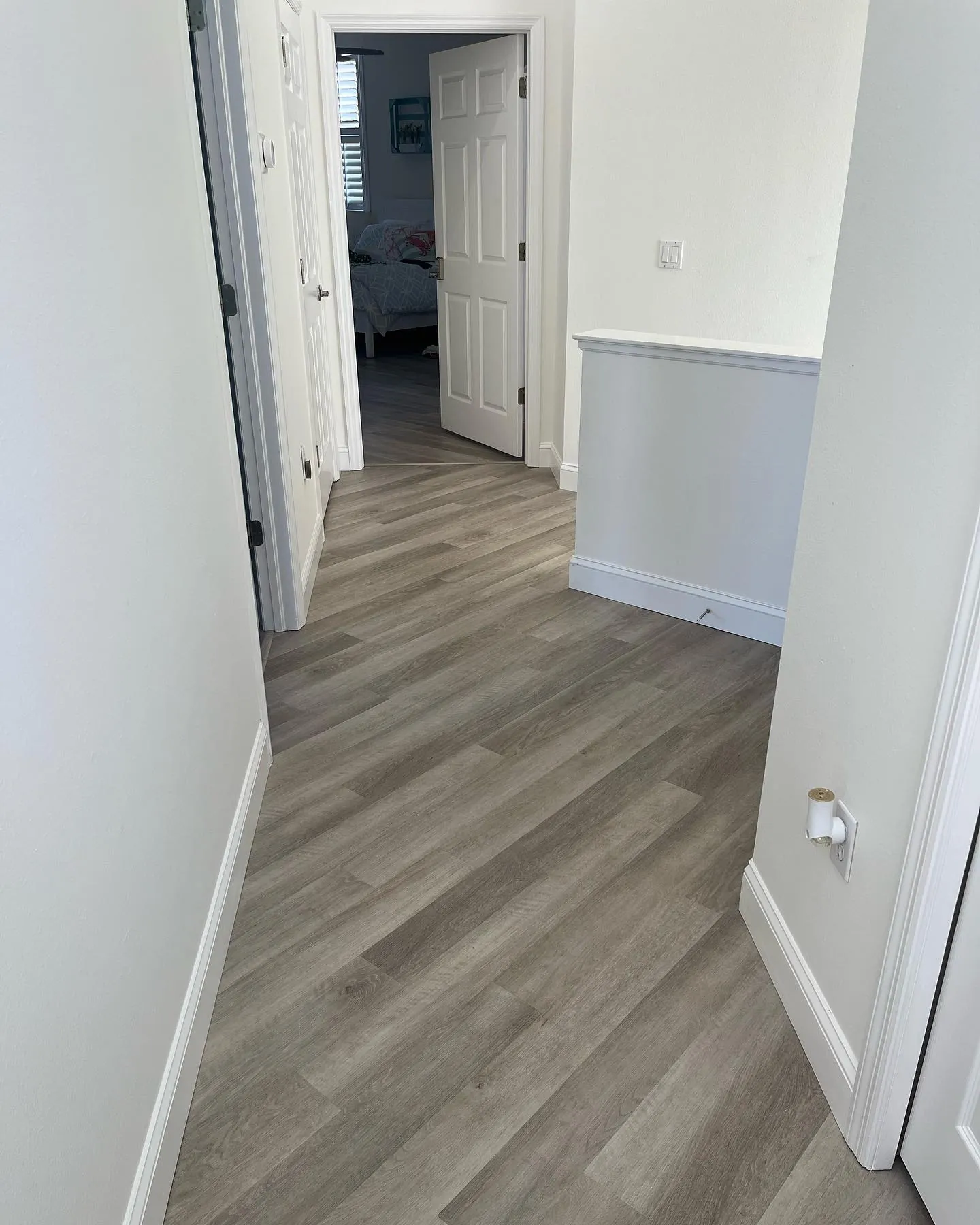 LVP hallway gray with bedroom view Holiday FL