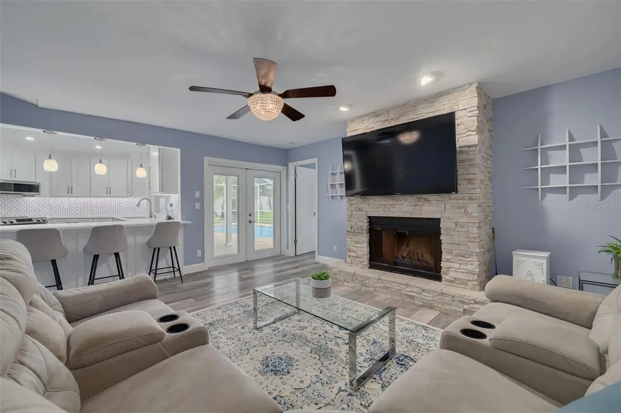 LVP living room stone fireplace open plan installed by Carpet Corner Carpet One Holiday FL