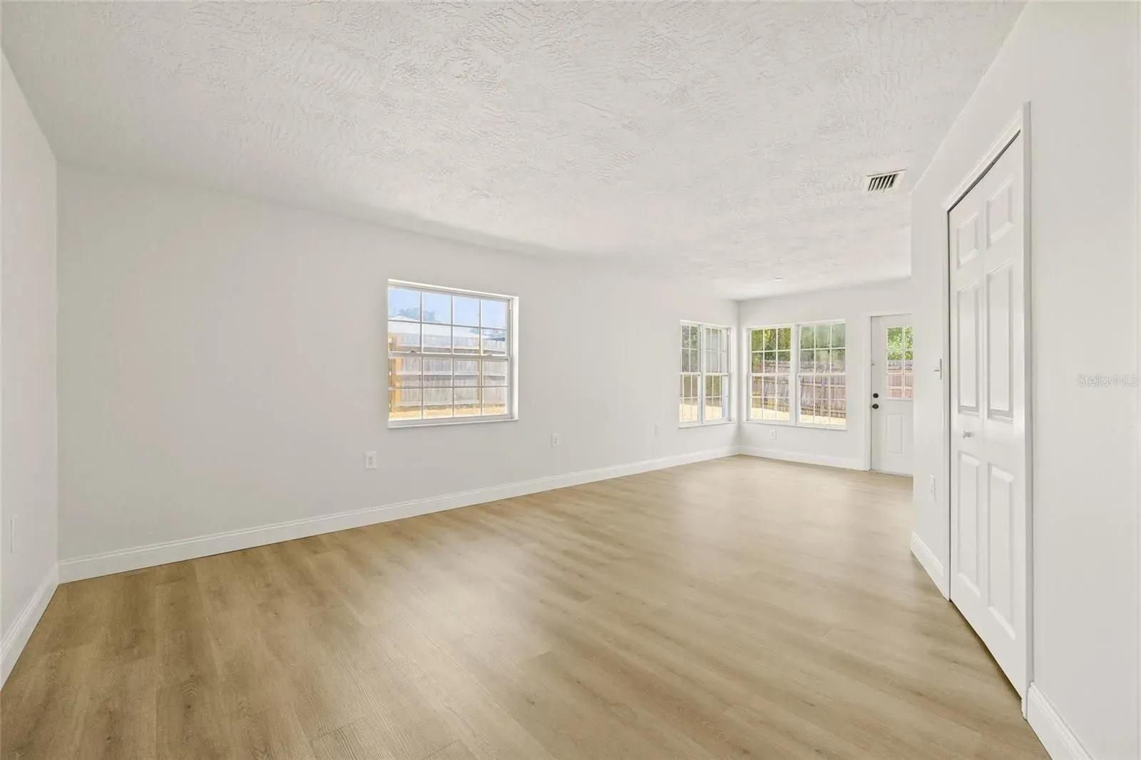 LVP living room bright windows Holiday FL