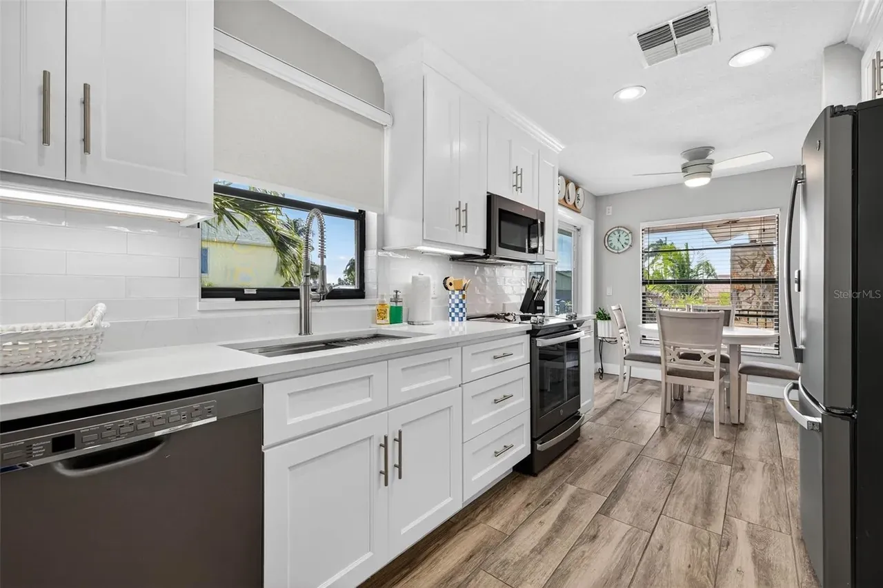 Wood-look tile kitchen sink white cabinets Holiday FL